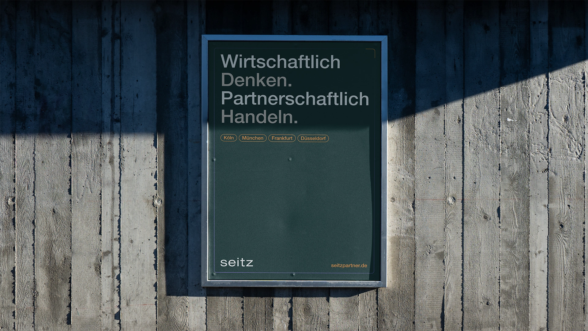 One picture shows a Seitz poster mockup on a wooden wall.